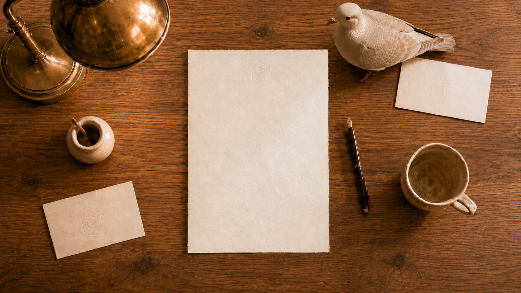 A writing desk with a blank letter, pen, cup and dove in The House of Nonduality.